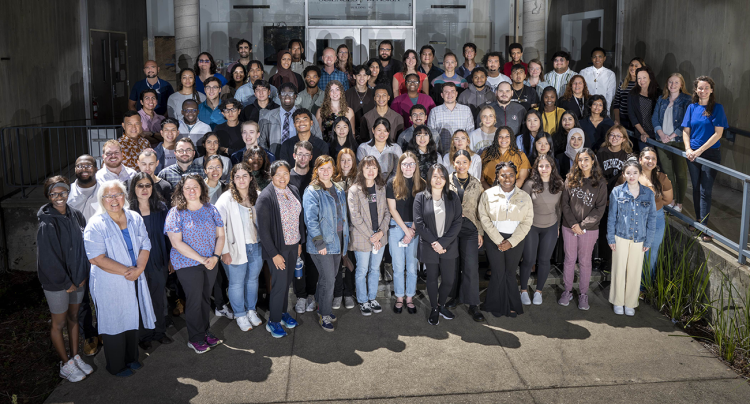 Large, diverse group photo of several rows of people standing in the entryway of a building at Berkeley Lab.