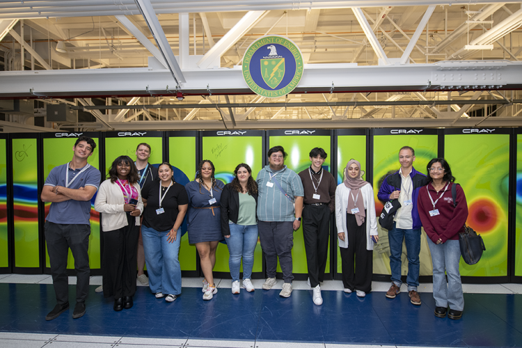 HPC Bootcamp participants pose with the Cori supercomputer in the machine room at NERSC.