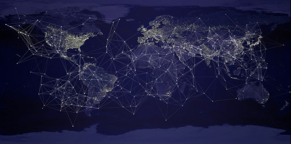 Artistic representation of a network across a night-view world map