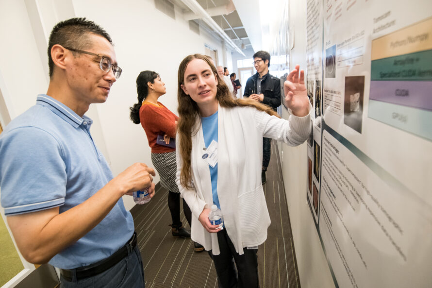 A 2018 summer researcher presents a poster to Berkeley Lab Scientist John Wu. (Credit: Berkeley Lab)