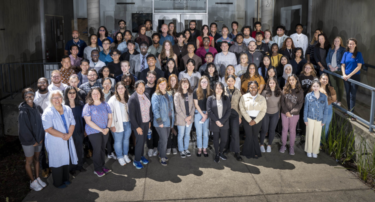 Large, diverse group photo of several rows of people standing in the entryway of a building at Berkeley Lab