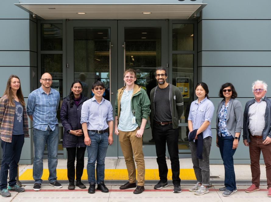 Group photo of nine Alvarez Fellow Alumni in front of Shyh Wang Hall.