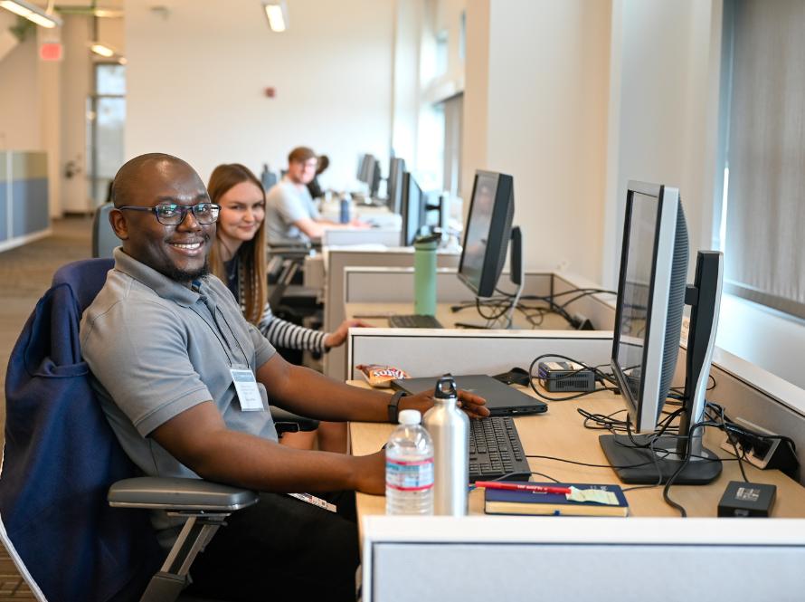 A small, diverse group of summer program students try out their workstations at Shyh Wang Hall.