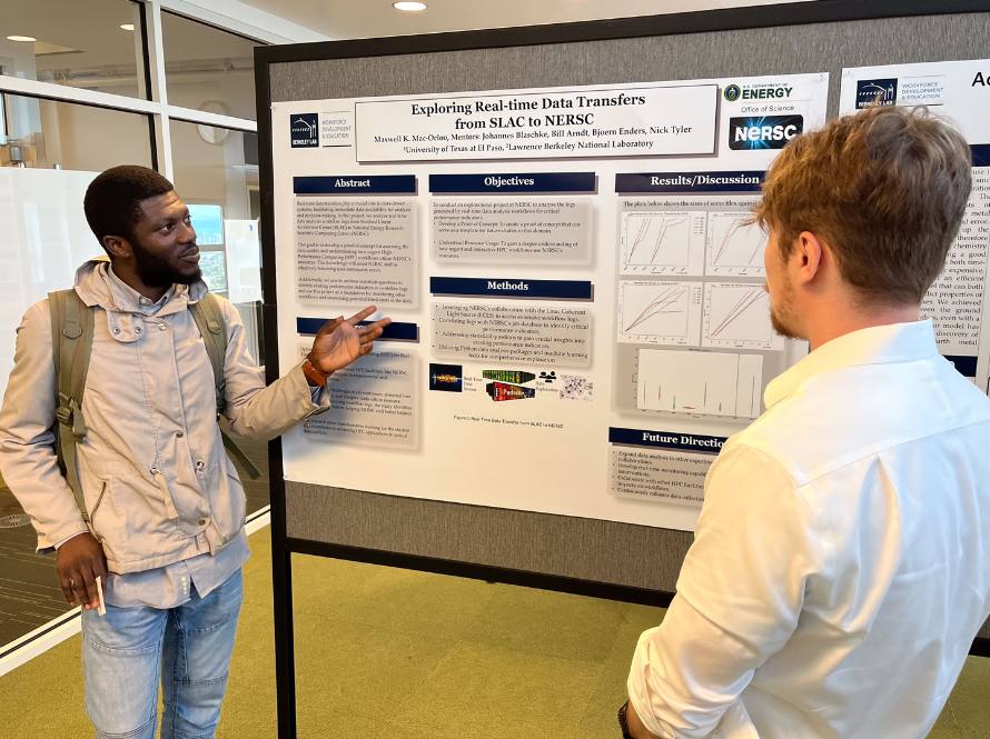 Maxwell Mac-Ocloo explains his scientific poster to a fellow summer program researcher during the 2023 Summer Poster Session.