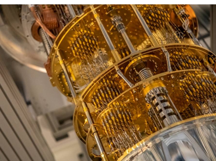 Photo of quantum gate hardware, comprised of gold and silver toned elements.