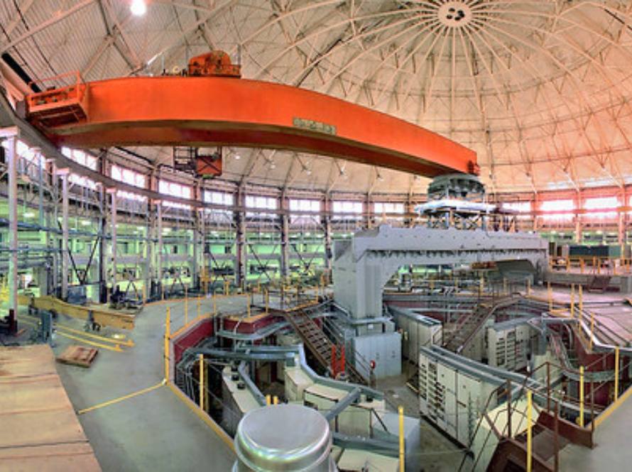 Photo of the interior of the Advanced Light Source Facility at Berkeley Lab, which is a domed room with high windows all around and several levels of machinery and walkways.