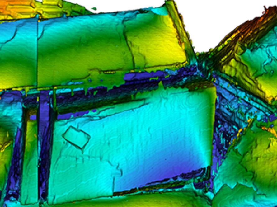 Iridescent, rainbow-colored grains of calcite shown at 1 micron resolution.