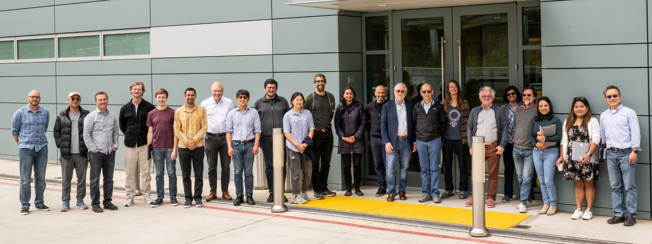 Group photo with all Alvarez fellows through 2022 lined up next to Shyh Wang Hall.