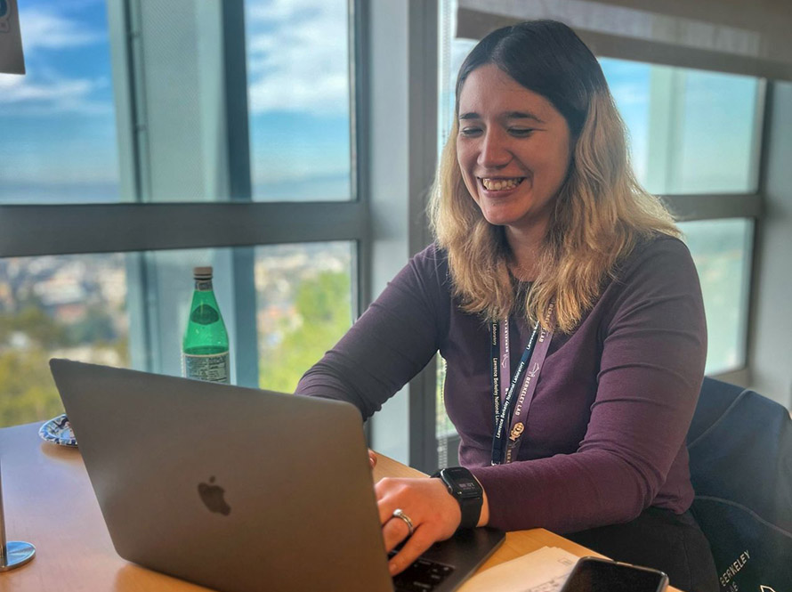 A scientist at a laptop in a break room space of Shyh Wang Hall during the AI Jam event.