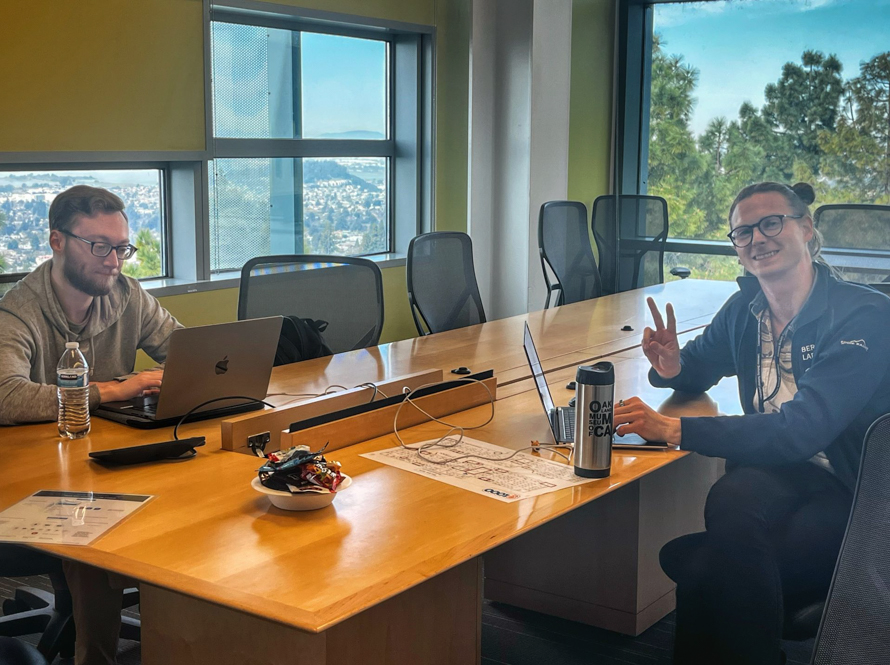 Two AI Jam participants occupied a board room in Shyh Wang Hall.