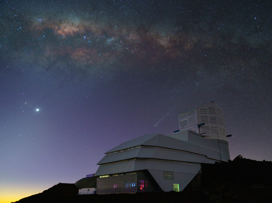 Twilight photo of Rubin Observatory with starry night sky above.