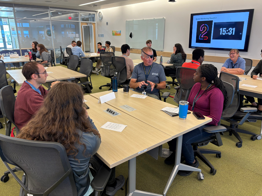 Scientists and summer students exchange ideas and expertise in an open setting at Wang Hall.