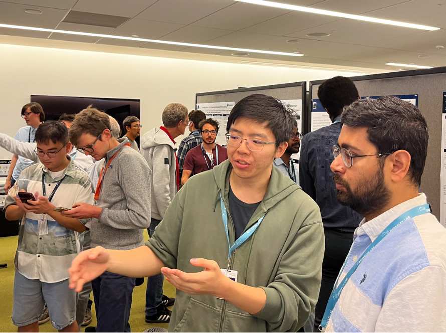 Many summer students and senior scientists participate in active discussions during the 2025 summer student poster session.