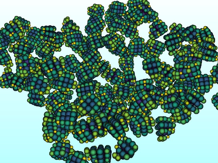 3D molecular visualization showing a cluster of densely packed, interconnected molecules represented as green and yellow spheres, arranged in a complex, irregular pattern against a light blue background.