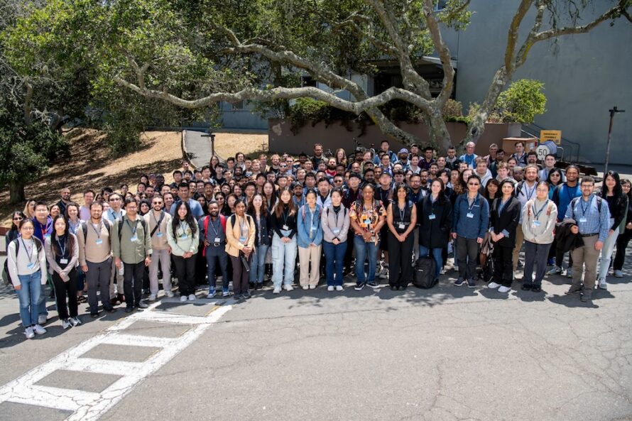 Photo of a large group of people standing under a tree at Berkeley Lab