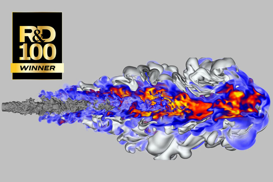 A high-resolution 3D computer simulation of a turbulent flame expanding from left to right against a light grey background. The simulation shows a textured, silver-grey plume of fuel igniting into a bright core of blue, red, orange, and yellow colors representing intense heat and complex chemical reactions. In the top left corner is a black and gold badge that reads R&D 100 WINNER.